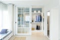 Modern wardrobe with black and blue cloth hanging.