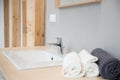 White modern wash basin and towels in hotel bathroom Royalty Free Stock Photo