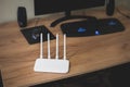 White Modern Wi-Fi router on the table in room. Wireless ethernet connection signal Royalty Free Stock Photo