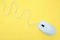 White modern wired computer mouse on yellow background Royalty Free Stock Photo