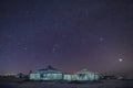 The white Mongolian yurts in night starry sky in winter