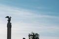 White monument blue sky and palm morning