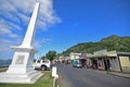 White monument with row of shops with old cowboy design building at Levuka, Ovalau island, Fiji