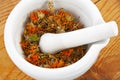 White mortar with dry marigold flower