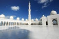 White mosque with cloudy blue sky