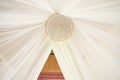 White mosquito net over a bed in a luxurious hotel Royalty Free Stock Photo