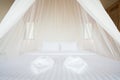 White mosquito net over a bed in a luxurious hotel Royalty Free Stock Photo