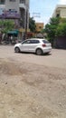 White motor car drives in the centre of town