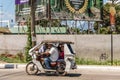 White motor-tricycle taxi on the move in Puerto Princesa, Palawan, Philippines