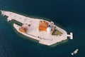 White motor yacht sails on the sea around the island of Gospa od Skrpjela. Montenegro. Top view Royalty Free Stock Photo