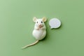 White mouse showing paws with empty speech bubble on green background Royalty Free Stock Photo
