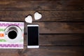 White mug of coffee and two marshmallows in the shape of hearts on a wooden background for breakfast Royalty Free Stock Photo