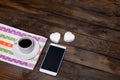 White mug of coffee and two marshmallows in the shape of hearts on a wooden background for breakfast Royalty Free Stock Photo