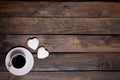 White mug of coffee and two marshmallows in the shape of hearts on a wooden background Royalty Free Stock Photo