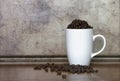 White Mug full of Coffee Beans