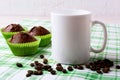 White mug mockup with chocolate muffins on green checkered napki Royalty Free Stock Photo