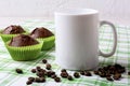 White mug mockup with chocolate muffins on green checkered napkin Royalty Free Stock Photo