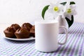 White mug mockup with chocolate muffins on plate Royalty Free Stock Photo