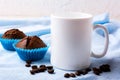 White mug mockup with coffee beans and two chocolate muffins Royalty Free Stock Photo