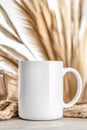 White mug mockup displayed on a textured boho background with neutral tones Royalty Free Stock Photo