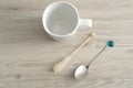 A white mug with a sugar stick and a teaspoon Royalty Free Stock Photo