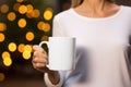 White mug in woman\'s hands mock up