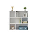 White Bookshelf with Various Items Including Books, Trophy, Plant, and Boxes storage Royalty Free Stock Photo