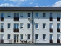 White multi level residential building. windows and balconies. blue sky Royalty Free Stock Photo