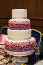 White multi level wedding cake with pink flower decorations Royalty Free Stock Photo