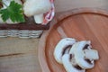 Fresh white mushrooms champignon in brown basket on wooden background. Top view. Copy space Royalty Free Stock Photo