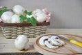 Fresh white mushrooms champignon in brown basket on wooden background. Top view. Copy space Royalty Free Stock Photo