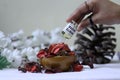 White Musk being pored on pot pourri with pine & flowers the background Royalty Free Stock Photo