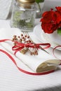 White napkin decorated with red ribbon Christmas plant, table se Royalty Free Stock Photo