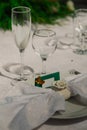 White napkin on a plate and a sign on the wedding table. empty glasses Royalty Free Stock Photo