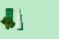 White medical nasal spray bottle on aqua mint background flat lay with harsh shadow minimalismstyle. COVID-19 pandemic