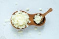 White natural beeswax pellets in wooden plate Royalty Free Stock Photo