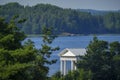 White neoclassical pavilion by the lake surrounded by forest Royalty Free Stock Photo
