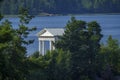 White neoclassical pavilion by the lake surrounded by forest Royalty Free Stock Photo