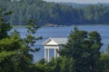 White neoclassical pavilion by the lake surrounded by forest Royalty Free Stock Photo