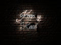 White Neon Sign Text saying Keep it real over a red brick wall