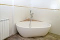 White new bath, white tiles and the battery in the mikvah