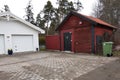 White new garage for two cars and wooden barn on private house yard Royalty Free Stock Photo