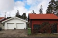 White new garage for two cars and wooden barn on private house yard Royalty Free Stock Photo