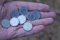 white new Ukrainian coins lie on a brown palm on a hand