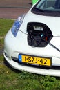 White Nissan Leaf being charged.