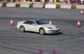 White Nissan sports car ready to do a burnout at a show..