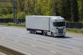 White no name lorry travelling on the the motorway in a sunny day with no other cars around Royalty Free Stock Photo
