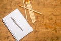 White note pad with steel pen on a wooden table. Copy space Royalty Free Stock Photo