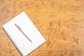 White note pad with steel pen on a wooden table. Copy space Royalty Free Stock Photo