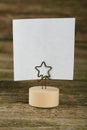 White note paper on a holder on a brown wooden background Royalty Free Stock Photo